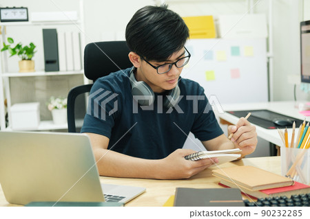 Young man study in front of the laptop computer at home 90232285