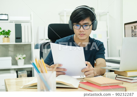 Young man study in front of the laptop computer at home Young man study in front of the laptop computer at home 90232287
