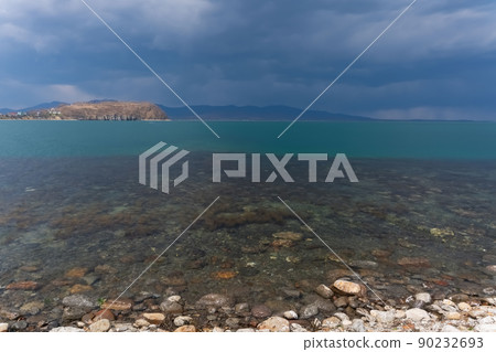 Dark blue clouds and sea or ocean water surface with dramatic seascape Dark blue clouds and sea or ocean water surface with dramatic seascape 90232693