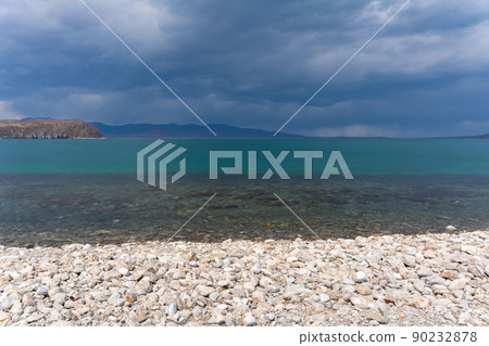 Dark blue clouds and sea or ocean water surface with dramatic seascape Dark blue clouds and sea or ocean water surface with dramatic seascape 90232878