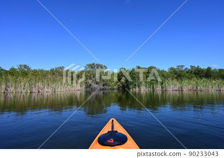 Orange kayak on Nine Mile Pond in Everglades National Park, Florida. 90233043