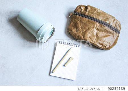 Pen, bag and cardboard cup made of recycled paper. Environmentally friendly stationary supplies. Eco friendly modern ecological biomaterials. Plastic pollution reduction concept. Zero waste concept Pen, bag and cardboard cup made of recycled paper. Environmentally friendly stationary supplies. Eco friendly modern ecological biomaterials. Plastic pollution reduction concept. Zero waste concept 90234189