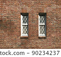 Textured background Red brick wall with two windows 90234237