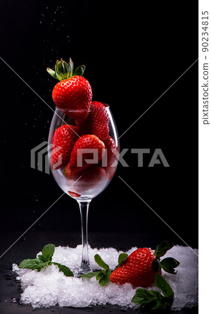 Strawberries in glass on the black background 90234815