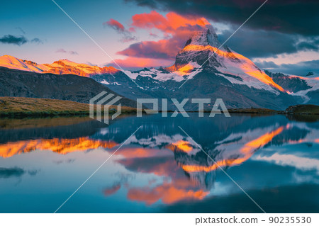 Famous misty Matterhorn and Stellisee lake at sunrise, Zermatt, Switzerland 90235530