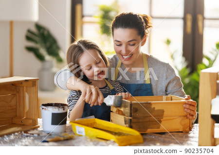 mother and daughter painting a wooden box 90235704