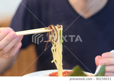 Scooping with chopsticks to eat Iekei Ramen Scooping with chopsticks to eat Iekei Ramen 90236031