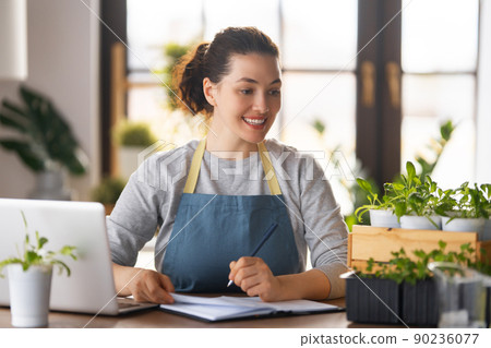 Woman caring for plants 90236077