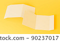 A4. Blank trifold paper brochure mock-up on yellow background with soft shadows. 3D illustration 90237017
