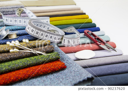 Pieces of cloth with scissors, needle and thread. Tailoring, manufacture of upholstered furniture. 90237620