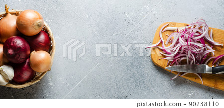 Sliced red onion on wooden chopping Board. Top view. Space for text Sliced red onion on wooden chopping Board. Top view. Space for text 90238110