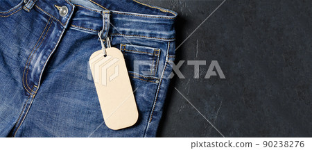 Denim. Blue jeans on black background. Label for writing text. Copy space. The concept of selling goods in the store. 90238276