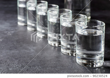 Six shots of vodka in a row. Copy space 90238524