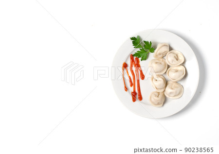 Traditional Russian pelmeni, ravioli, dumplings on a white plate with red sauce and parsley. White background. Traditional Russian pelmeni, ravioli, dumplings on a white plate with red sauce and parsley. White background. 90238565