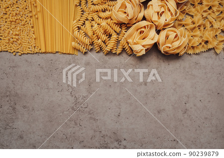 Flat Lay of Different Types of Pasta Laid Up on Top of the Table with Copy Space on the Bottom Flat Lay of Different Types of Pasta Laid Up on Top of the Table with Copy Space on the Bottom 90239879