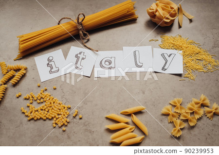 Lettering with Different Types of Pasta and Handful of Spaghetti Scattered on the Table Lettering with Different Types of Pasta and Handful of Spaghetti Scattered on the Table 90239953