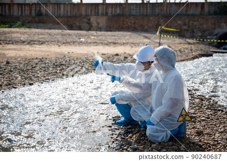 Ecologist sampling water from river with test tube glass and have white smoke Ecologist sampling water from river with test tube glass and have white smoke 90240687