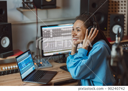 Podcasting, music and radio concept - close-up of African American woman speaking on the radio, working as a presenter 90240742