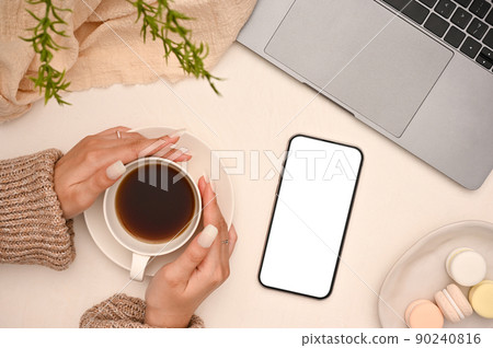 A female hands holding a cup of coffee in her minimal beautiful workspace office desk 90240816