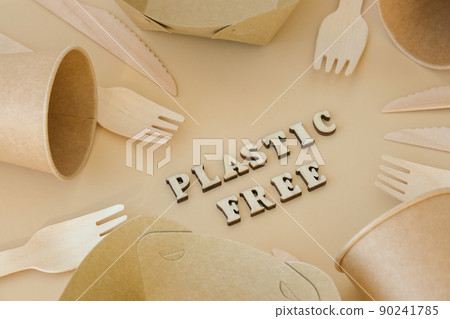 PLASTIC FREE text around Eco friendly, disposable, recyclable, compostable tableware. Paper food boxes, dishes on neutral beige background. Sustainable lifestyle concept. Flat lay 90241785