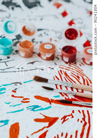 Acrylic paints on numbered canvas. Picture by numbers. Creative hobby. Painting for beginners. Hobbies for stay home lockdown, anti-stress idea. Meditation, relax concept education. Leisure activity. 90241804