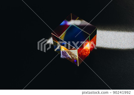 Colorful bright glass prism cube  Refracting light in vivid rainbow colors. 90241992