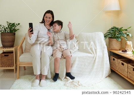 Mother and Son Video Calling Grandparents 90242545