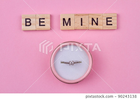 Wooden cubes with inscription be mine and gift box with engagement ring. Wooden cubes with inscription be mine and gift box with engagement ring. 90243138