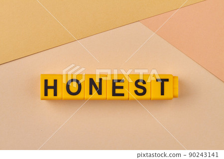 The word honest written on yellow cubes close up. 90243141