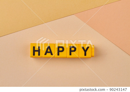 The word HAPPY written on yellow cubes close up. The word HAPPY written on yellow cubes close up. 90243147