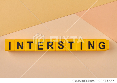 Creative flat lay from plastic cubes with inscription interesting. 90243227