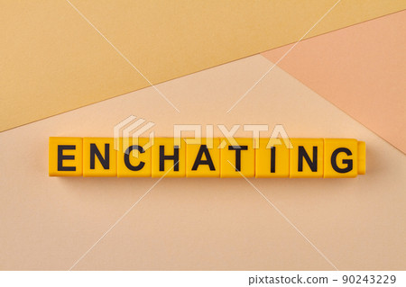 Enchanting word written on alphabet blocks on light background close up. 90243229