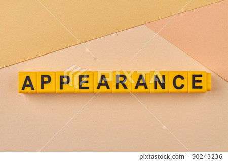 Yellow cubes with inscription appearance on color background close up. 90243236