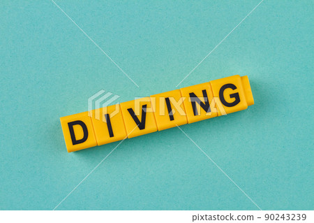 The word diving written on yellow cubes close up. 90243239