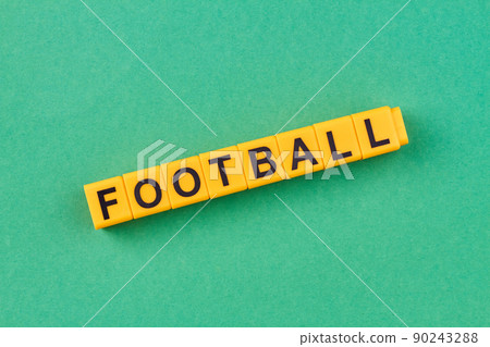 Yellow cubes with inscription football on green background. Yellow cubes with inscription football on green background. 90243288