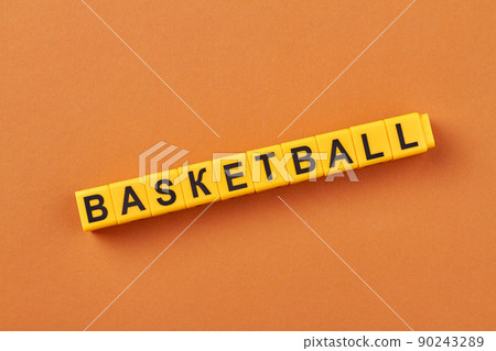 The word basketball written on yellow cubes against color background. The word basketball written on yellow cubes against color background. 90243289