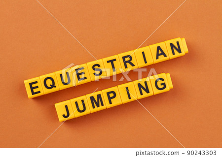 The inscription equestrian jumping written on yellow cubes against color background. 90243303