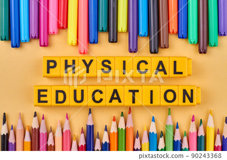 The inscription physical education written on yellow cubes against color background. The inscription physical education written on yellow cubes against color background. 90243368