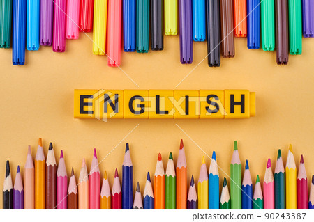 The word ENGLISH written on plastic cubes in frame from colored school supplies. The word ENGLISH written on plastic cubes in frame from colored school supplies. 90243387