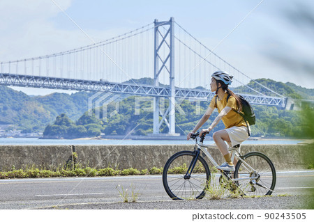 A local woman enjoying cycling on the Shimanami Kaido A local woman enjoying cycling on the Shimanami Kaido 90243505