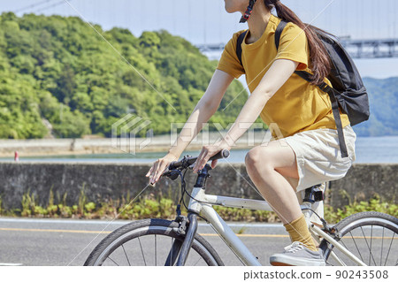 A local woman enjoying cycling on the Shimanami Kaido 90243508