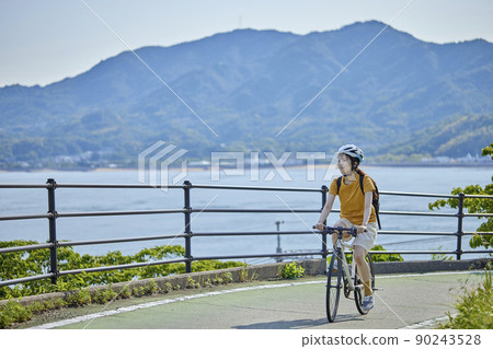 A local woman enjoying cycling on the Shimanami Kaido 90243528