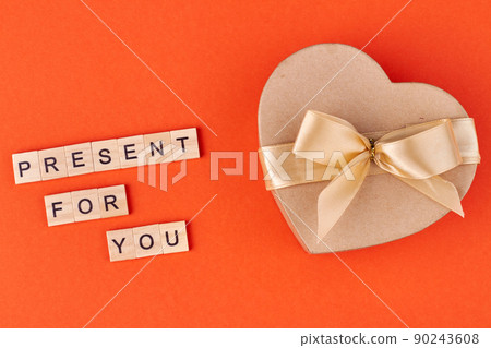 Beautiful heart-shaped gift box with bow on color background. Beautiful heart-shaped gift box with bow on color background. 90243608