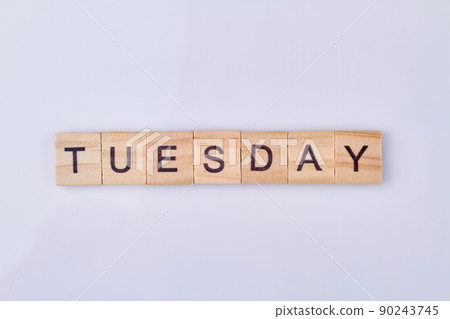 Tuesday word written with vintage wooden cubes and black letters. 90243745
