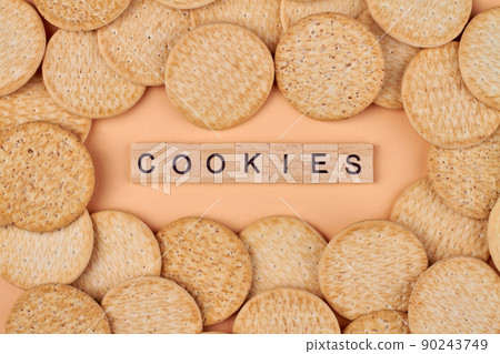 Creative flat lay with round healthy cookies and wood cubes with text cookies. Creative flat lay with round healthy cookies and wood cubes with text cookies. 90243749