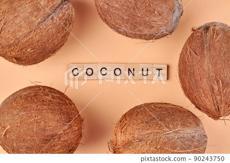 Five brown coconuts and inscription coconut from wooden cubes. Five brown coconuts and inscription coconut from wooden cubes. 90243750