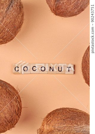 Brown whole tropical coconut fruits on color background. Brown whole tropical coconut fruits on color background. 90243751