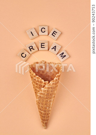 Waffle cone and wooden cubes with inscription ice-cream. Waffle cone and wooden cubes with inscription ice-cream. 90243753