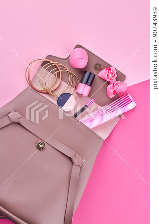 Female backpack with cosmetics and makeup accessories on color background. 90243939