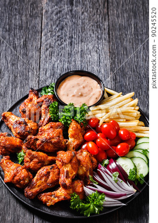 roast chicken wings with french fries and veggies 90245520